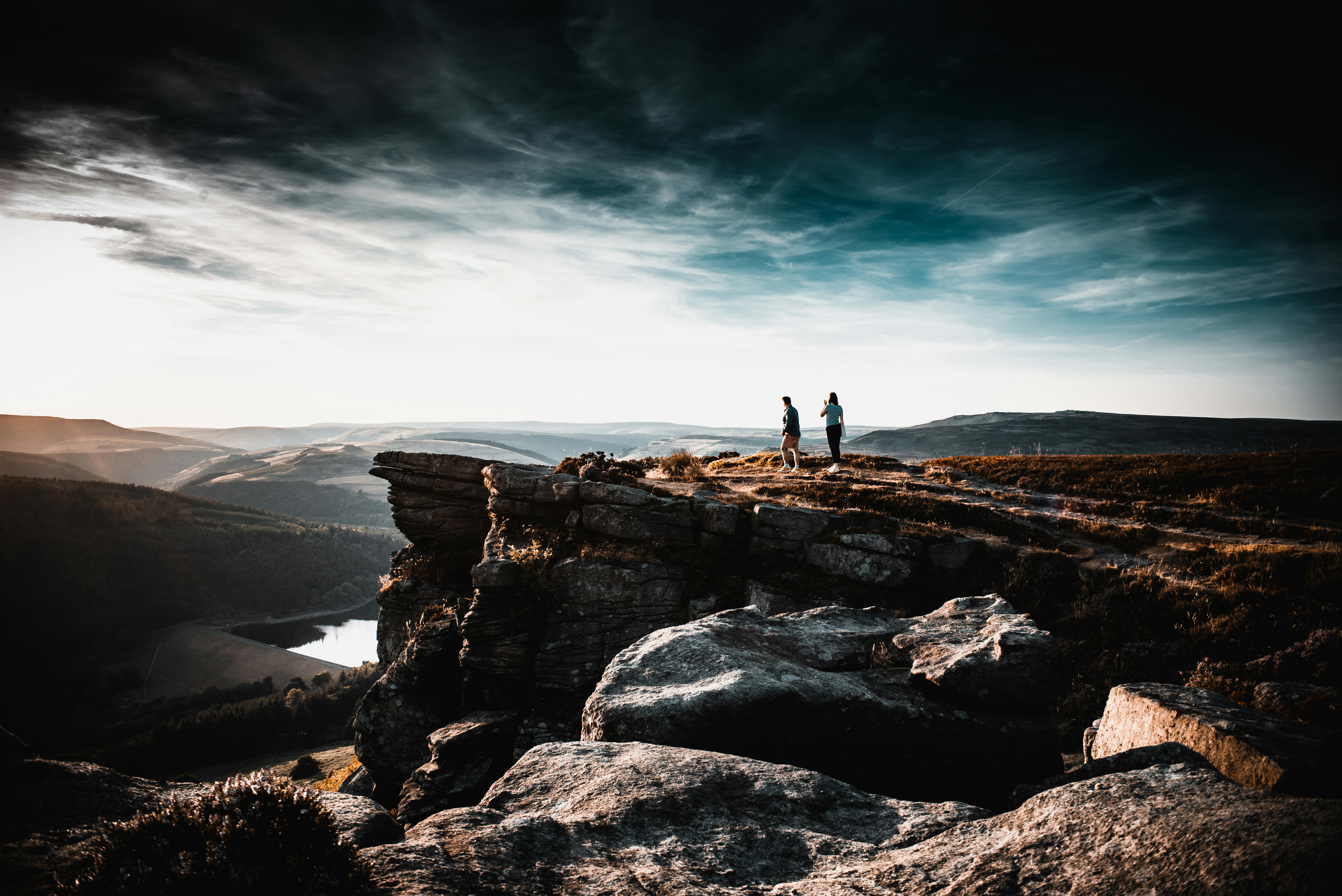 people standing on rock formation during daytime